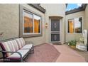 Inviting front patio with seating area and a charming water fountain at 35518 N 30Th Dr, Phoenix, AZ 85086