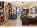 Home office with built-in bookshelves, a comfortable chair, and a large desk at 35518 N 30Th Dr, Phoenix, AZ 85086