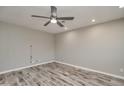 Simple bedroom with gray walls, wood floors, and ceiling fan at 9622 W Cinnabar Ave # B, Peoria, AZ 85345