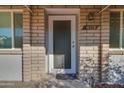 Gray front door with a brick facade and small entryway at 9622 W Cinnabar Ave # B, Peoria, AZ 85345