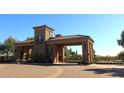 Gated community entrance with stone pillars and wrought iron gates at 2652 E Pelican Ct, Gilbert, AZ 85297