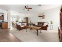 Spacious living room with plush carpeting and stylish brown sofas and decor at 17552 W Young St, Surprise, AZ 85388