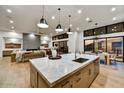 Modern kitchen island with marble countertop and stainless steel appliances at 9930 E Miramonte Dr, Scottsdale, AZ 85262