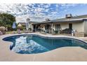 Inviting backyard pool with lounge chairs, covered patio, and outdoor grill, perfect for relaxation and entertainment at 19219 N 33Rd Ave, Phoenix, AZ 85027