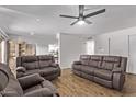 Bright living room with ceiling fan and hardwood floors, illuminated by natural light at 728 W Grove Cir, Mesa, AZ 85210