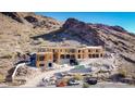 Aerial view of a large house under construction on a hillside at 21137 N 102Nd St, Scottsdale, AZ 85255