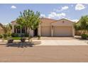 Charming single-story home with a terracotta-tiled roof and well-manicured front yard at 10331 E Wavelength Ave, Mesa, AZ 85212