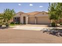 Inviting single-Gathering home featuring a three-car garage, landscaped yard, and barrel tile roof at 10331 E Wavelength Ave, Mesa, AZ 85212