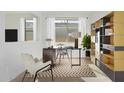 Bright home office with modern desk, stylish shelving, and herringbone rug, perfect for remote work at 16173 S 181St Ave, Goodyear, AZ 85338
