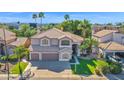 An aerial view of the beautiful two-story home, showcasing its lush landscaping, tile roof, and convenient three-car garage at 760 N Ithica St, Gilbert, AZ 85233