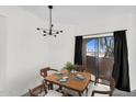 Well-lit dining area with seating for four and sliding glass door access to outdoor patio at 10030 W Indian School Rd # 218, Phoenix, AZ 85037