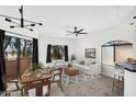 Cozy living room with a large window, comfortable seating, and an open connection to the dining area at 10030 W Indian School Rd # 218, Phoenix, AZ 85037