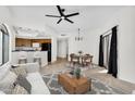 Bright living room with modern decor, an open floor plan, and views of the adjacent kitchen and outdoor patio at 10030 W Indian School Rd # 218, Phoenix, AZ 85037