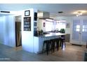 Open concept kitchen with a breakfast bar featuring granite countertops and bar stool seating at 14609 N Montego Ct, Phoenix, AZ 85053