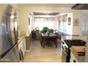 Bright kitchen with stainless steel appliances and a view into the dining area at 14609 N Montego Ct, Phoenix, AZ 85053