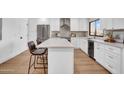 Beautiful modern kitchen with island seating, stainless steel appliances and white cabinetry at 2126 E Watson Dr, Tempe, AZ 85283