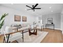 Bright living room with a ceiling fan, modern decor, light hardwood floors and lots of natural light at 2126 E Watson Dr, Tempe, AZ 85283