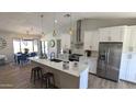 Spacious kitchen featuring a large island, stainless steel appliances, and adjacent dining area at 4442 E Aire Libre Ave, Phoenix, AZ 85032
