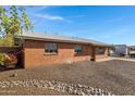 Brick home featuring desert landscaping with a rock drainage system, and a covered carport at 2246 W Mulberry Dr, Phoenix, AZ 85015