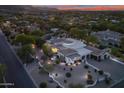Stunning aerial view of an expansive property with a circular driveway and beautifully landscaped grounds at dusk at 6620 E Stallion Rd, Paradise Valley, AZ 85253