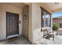 Charming front porch showcasing a cozy bench and a welcoming entrance with decorative door mat at 1264 E Walnut Rd, Gilbert, AZ 85298