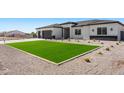 Inviting single-story home with a lush green lawn and desert landscaping at 18083 W Amber Dr, Goodyear, AZ 85338