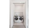 Convenient laundry closet with side-by-side washer and dryer and ample shelving at 908 W Caldwell St # 18, Phoenix, AZ 85041