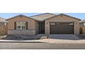 Single-story home with a two-car garage and desert landscaping at 36853 W La Paz St, Maricopa, AZ 85138