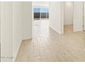 Light and bright hallway with wood-look tile flooring at 36853 W La Paz St, Maricopa, AZ 85138