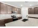 Modern kitchen features stainless steel appliances, white subway tile backsplash, and quartz countertops at 18156 W Cielo Grande Ave, Surprise, AZ 85387