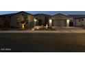 Charming single-story home with desert landscaping and a welcoming front entrance at dusk at 2072 E Blackhawk Ct, Gilbert, AZ 85298