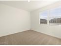 Simple bedroom with carpeted flooring and neutral wall colors at 36894 W La Paz St, Maricopa, AZ 85138
