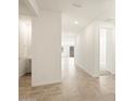 Bright hallway with tile flooring and access to bathroom and other rooms at 36894 W La Paz St, Maricopa, AZ 85138
