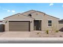 Charming single-story home with a well-manicured front yard and a two-car garage under a sunny, blue sky at 4958 W Hunter Trl, San Tan Valley, AZ 85144