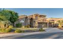 Two-story home with stone accents, a three-car garage, and lush landscaping at 1622 E Nighthawk Way, Phoenix, AZ 85048