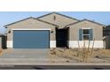 One-story house with blue garage door, landscaping, and light-colored exterior at 22550 W Tonopah Dr, Surprise, AZ 85387