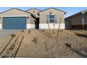 One-story house with blue garage door, landscaping, and light-colored exterior at 22550 W Tonopah Dr, Surprise, AZ 85387