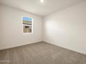 Bright bedroom with neutral carpet and window at 36914 W La Paz St, Maricopa, AZ 85138