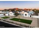 Aerial view of custom home with xeriscaping, stone accents, and mountain views at 9810 N 57Th St, Paradise Valley, AZ 85253