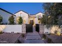 Exterior dusk shot of a well landscaped single Gathering home with stone and stucco accents at 9810 N 57Th St, Paradise Valley, AZ 85253