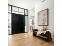 Contemporary foyer with wood floors, large front door, and neutral color palette at 9810 N 57Th St, Paradise Valley, AZ 85253
