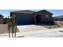 Inviting single-story home with a two-car garage, complemented by a low maintenance landscaped front yard at 20293 N 225Th Dr, Surprise, AZ 85387