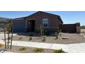 Attractive single-story home featuring well-maintained landscaping, a two car garage, and a welcoming entrance at 20293 N 225Th Dr, Surprise, AZ 85387