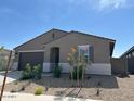 Single-story home with a mix of modern style and desert landscaping on a sunny day at 20357 N 225Th Dr, Surprise, AZ 85387