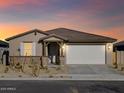Single story house with a two-car garage and desert landscaping at 22526 W Tonopah Dr, Surprise, AZ 85387