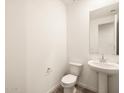 Simple bathroom with white pedestal sink and toilet at 36954 W La Paz St, Maricopa, AZ 85138