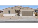 Newly constructed tan house with a brown garage door and desert landscaping at 36954 W La Paz St, Maricopa, AZ 85138