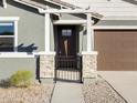 Attractive front entry with stone pillars and an iron gate at 37406 W San Clemente St, Maricopa, AZ 85138