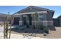 Charming single-story home featuring a stone accent facade and a two-car garage at 20331 N 225Th Dr, Surprise, AZ 85387