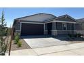 Charming single-story home featuring a stone accent facade and a two-car garage at 20331 N 225Th Dr, Surprise, AZ 85387